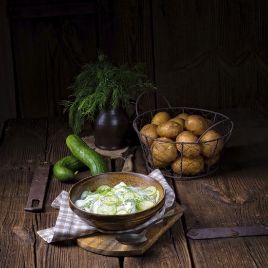 Fresh cucumber salad with yoghurt and young potatoes
