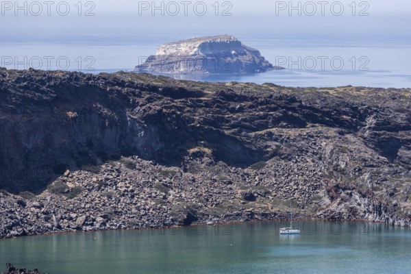 Volcanic island Palea Kameni, behind Aspronisi, white island, uninhabited island, part of the