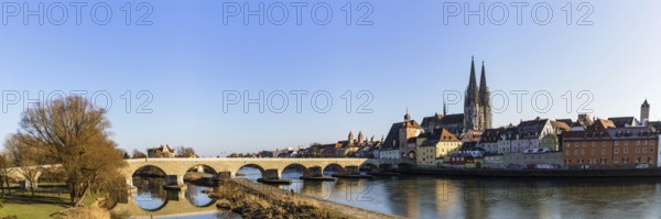 View of Regensburg Cathedral and the stone bridge over the Danube in winter in Regensburg, Bavaria,