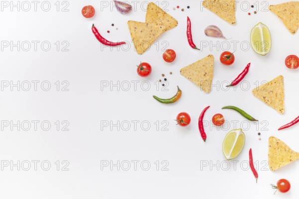 Creative Top view flat lay of fresh mexican food ingredients with tortilla nachos chips garlic