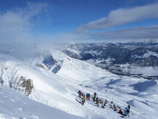 Situation on the summit of Haengst in Soerenberg, Switzerland, on a sunny winter day: A group of