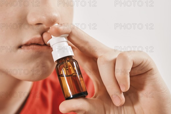 Blond Boy drips nose drops from runny nose. Treatment of colds and allergic rhinitis. Selective