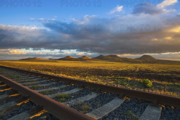 Single railway track at sunset, Central Bohemian Uplands, Czech Republic. Railway track in nature