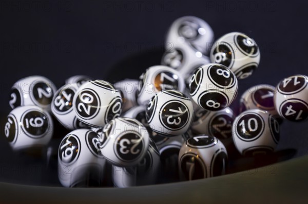 Black and white lottery balls in a bingo machine. Lottery balls in a sphere in motion. Gambling