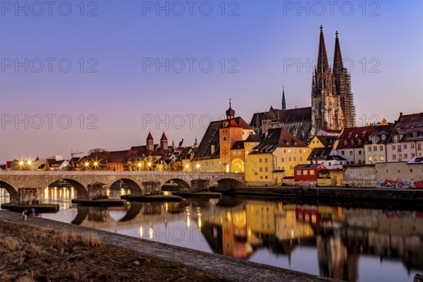 View of Regensburg Cathedral and the stone bridge over the Danube in winter in Regensburg, Bavaria,