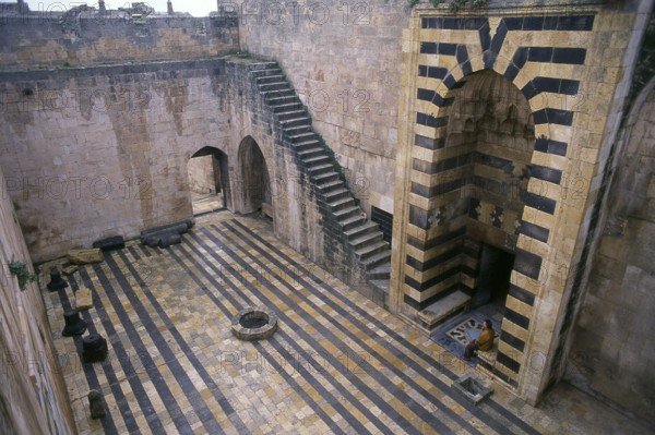 The Citadel of Aleppo is a large medieval fortified palace in the centre of the old city of Aleppo,
