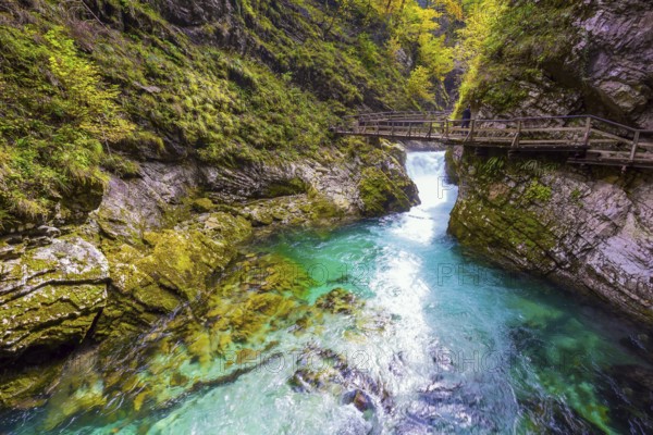 Slovenia. Bubbling waterfalls on a mountain river. On the slopes of the gorge laid wooden walkways