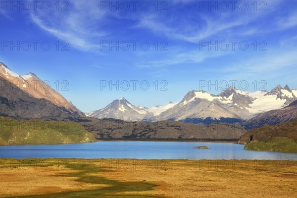 A blue lake in a picturesque valley surrounded by snow-capped mountains. National Park Perito