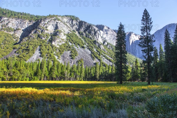 The monolithic rock El Capitan and majestic mountains surround the Yosemite Valley. The picturesque