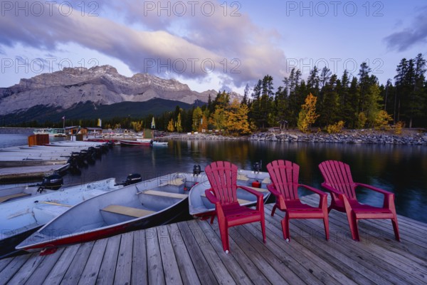 Beautiful autumn landscape scene in lake and mountain in background in west Canada, colour kayaks