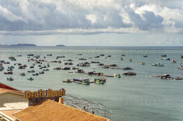 Calm sea with scattered boats and a cloudy sky in a coastal setting, palms, city, sun city, Phu