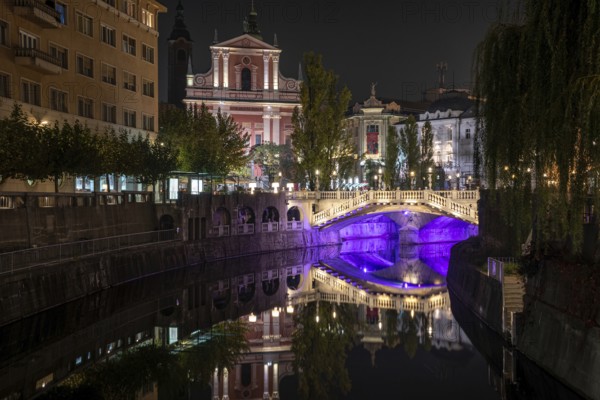 Famous three bridges at the Preseren square in the center of Ljubljana colorfully illuminated at