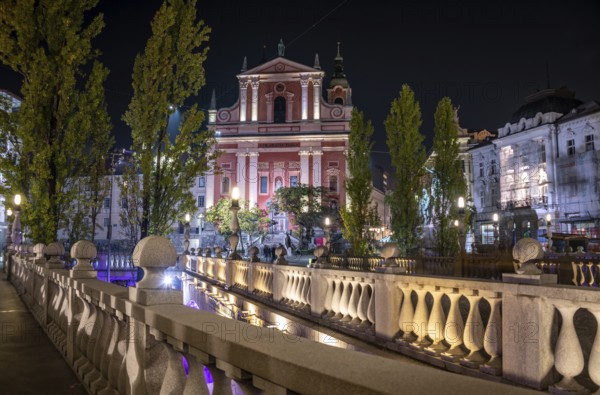 Famous Three Bridges and the Preseren square in the center of Ljubljana illuminated at night,