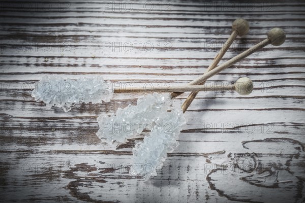 Sweet sugar sticks on vintage wooden board