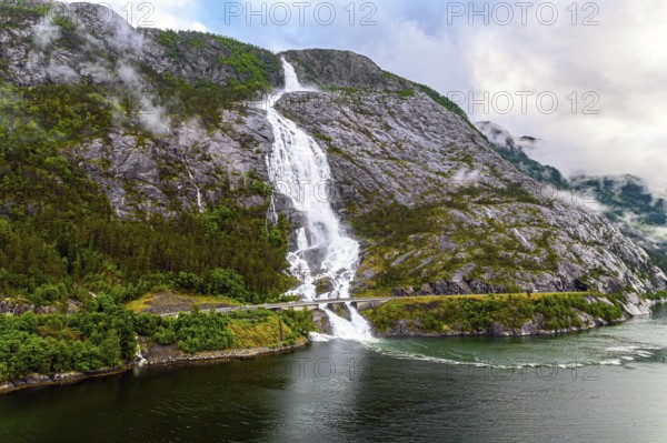 Western Norway. Langfossen cascade waterfall on the Vaule river. Passes through the highway. The