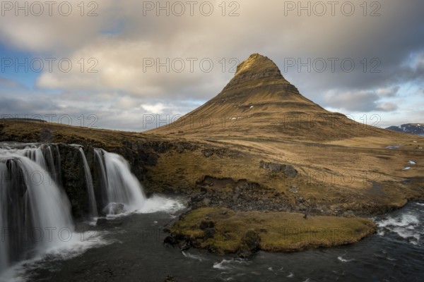 The Kirkjufell mountain and the kirkjufellfoss waterfall at grundarfjordur at Snaefellsnes