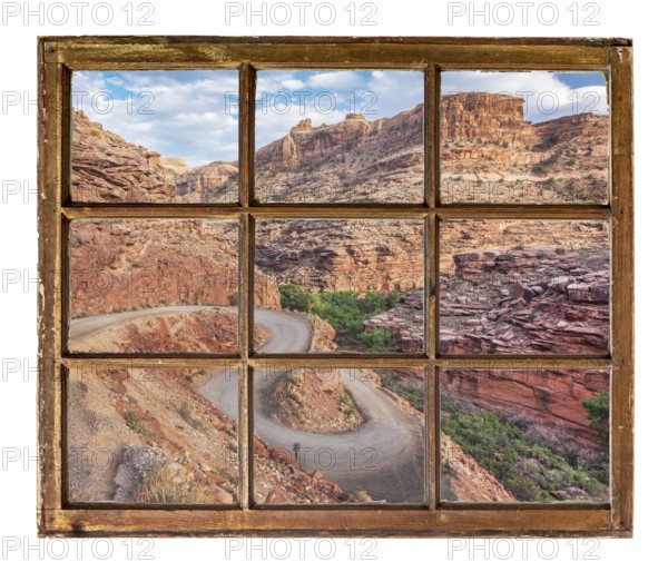 Windy canyon road as seen through vintage, grunge, sash window with dirty glass