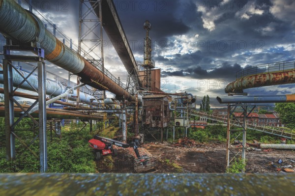 Complex industrial plant with rusted pipes and dilapidated building under a cloudy sky, HF6, Lost