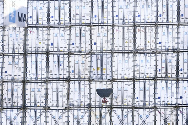 Stacked containers of the Danish logistics company Maersk on a container ship in the port of