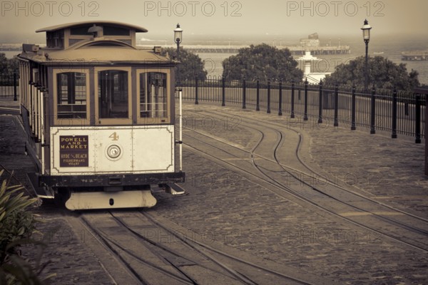 San Francisco cable car at Hyde Street turntable (Fisherman's Wharf) with foggy Aquatic Park in