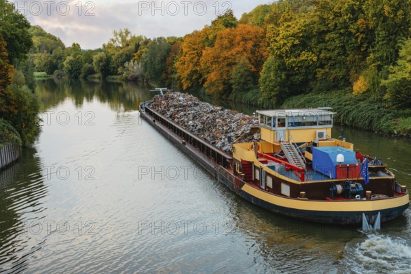 Transportation industry. Ship barge transports scrap metal and sand with gravel. Barge loaded with