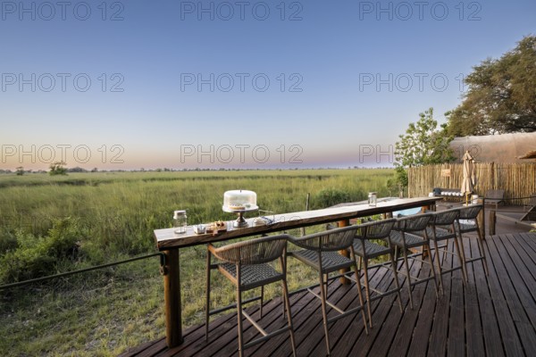 Terrace with bar on the main channel, Okuti Camp, Moremi Game Reserve, Okavango Delta, Maun,