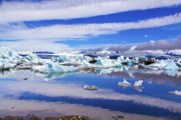 Clouds reflected in the smooth water of the largest glacial lagoon Jokulsaurloun. Iceland. Cold