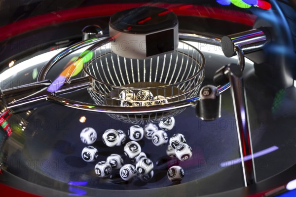 Black and white lottery balls in a rotating bingo machine. Lottery balls in a sphere in motion.