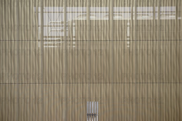 The outer façade of a combined heat and power plant made of perforated metal panels behind which