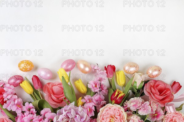 Festive easter banner, spring composition with decorated homemade eggs and blooming flowers,