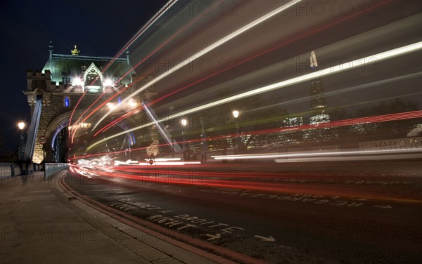 London, UK, December 10, 2015: London Tower Bridge, UK, at night with cars and buses leaving