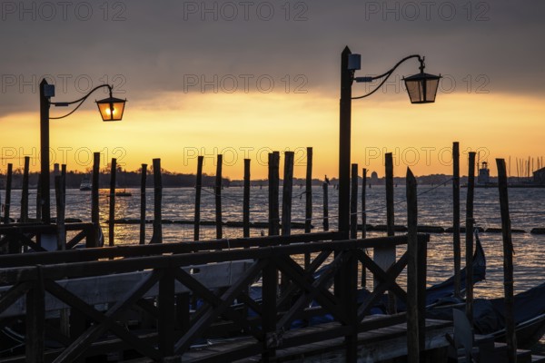 Morning atmosphere at sunrise, gondola jetty, lanterns, Venice, Italy
