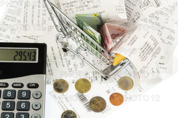 Shopping trolleys, banknotes and receipts, symbolising purchasing power, consumption and inflation