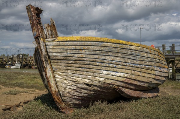 Rye Harbour, East Sussex, England, UK, May 12, 2022: An old shipwreck and some boats on the banks