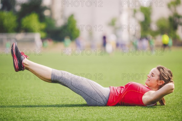 Theme sport and health. Young beautiful Caucasian woman doing warm-up, warming up muscles,