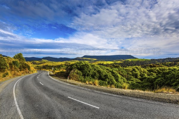 The road to Knight's Point Lookout. Asphalt highway among yellowed autumn vegetation. Picturesque