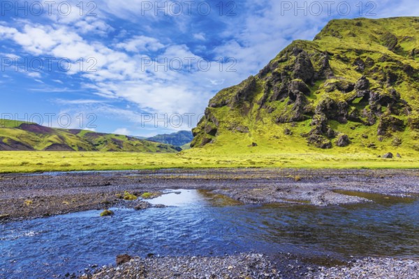 Pakgil Canyon - green grass and moss on the rocks. At the bottom of canyon flows small fast creek.