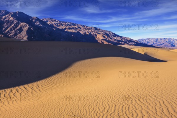 Mesquite Flat Sand Dunes. Bright solar morning in picturesque part of Death Valley. Slopes of sandy