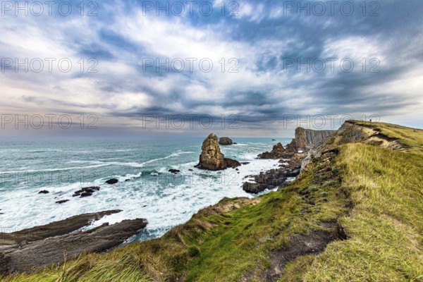 Portio beach. Rocky coastline of the Atlantic Ocean. Spanish coast, Cantabria. Stormy autumn day in