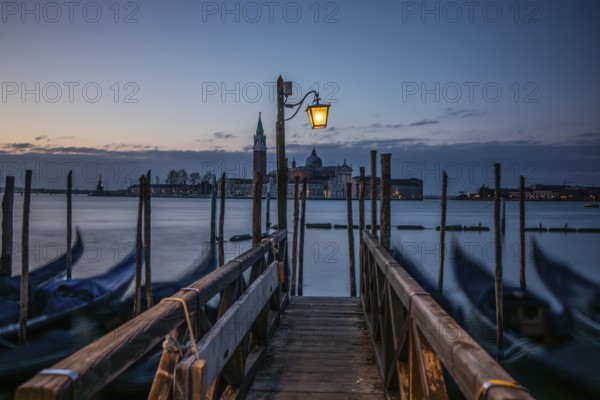 Morning atmosphere, Venetian gondolas with the church of San Giorgio Maggiore in the background,