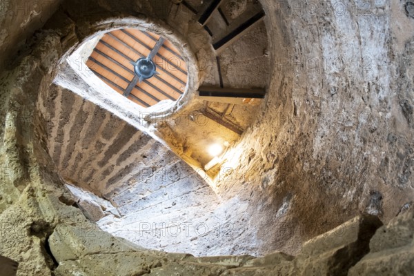 Ancient stairs of snail constructed in stone illuminated by the light of the Sun. Priego de