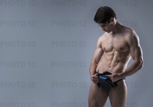 Muscular fit young male antique perfect muscles six packs of abs and bare chest. Bodybuilder model