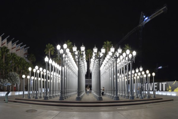 A picture of Urban Light, a public art designed by Chris Burden and unveiled in 2008, next to the