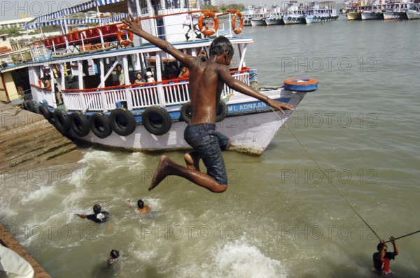 Children jumping and swimming into the Arabian Sea at Gateway of India, Bombay now Mumbai,