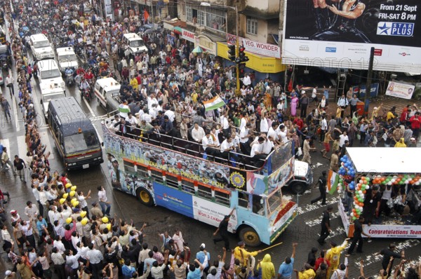 Twenty 20 team wave tri color Indian flags in special decorated bus during victory procession,