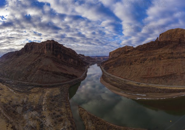 Colorado River and Red Sandstone Mountains on Cloudy Morning. Sky Reflection in Water. Grand