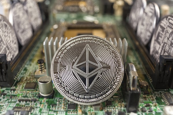 Ethereum coin close-up on a computer circuit motherboard as a blockchain technology payment network