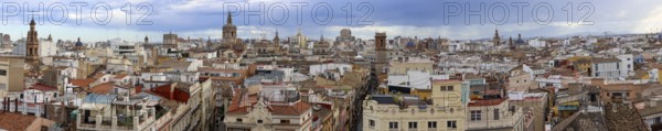 Panoramic photo of the rooftops of Valencia with the towers of the city's churches, as well as the