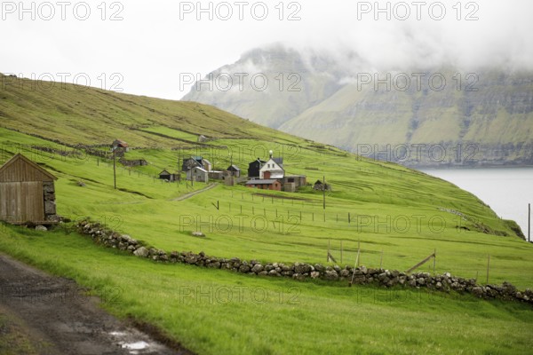 The village Muli on the Faroe Islands with green grass and few houses, Muli, Faroe Islands