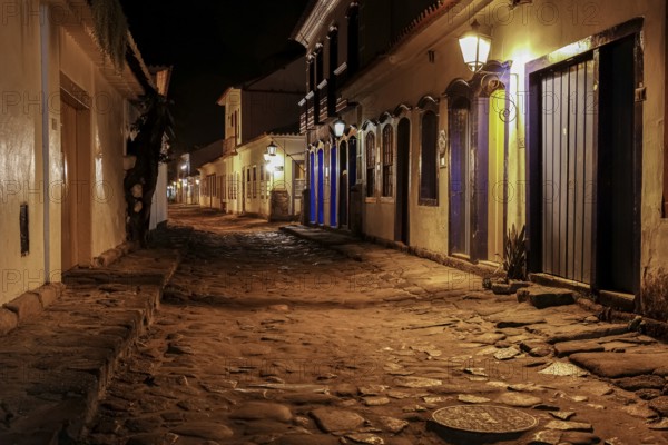 Atmospheric night view of illuminated street and buildings in historical center of Paraty, Brazil,